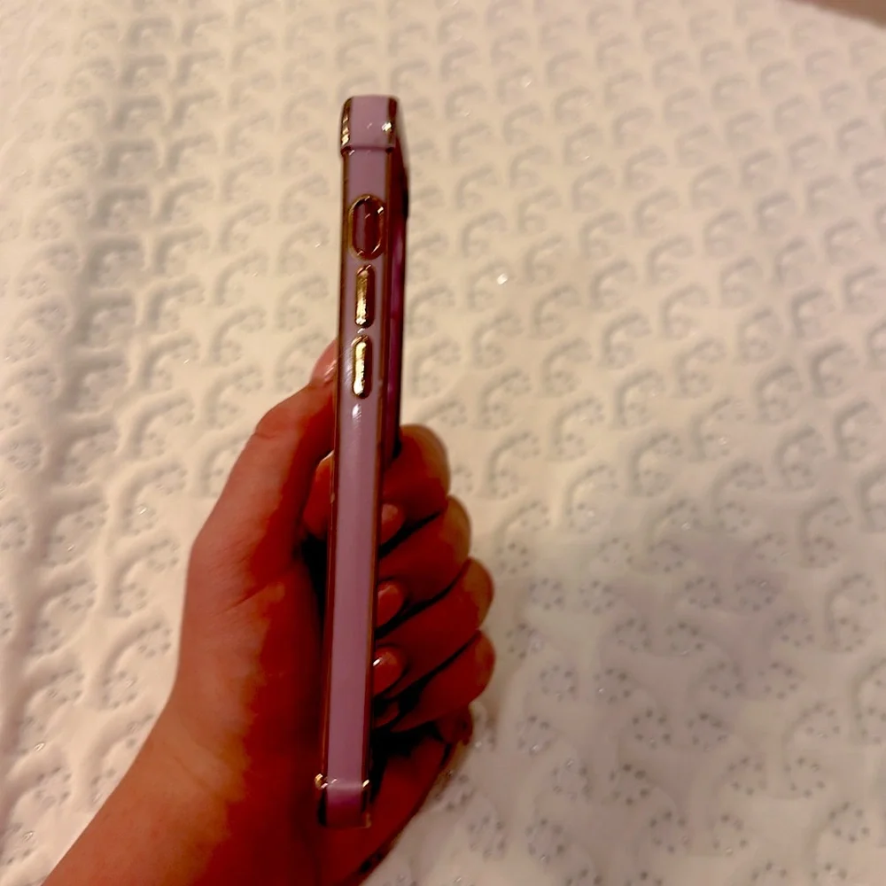 A light to medium purple LUTTY phone case with heart in the middle and designs